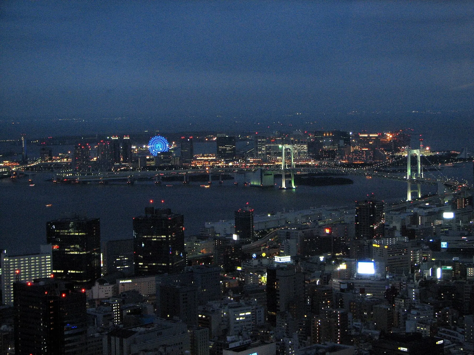 Odaiba at night, with lit buildings along the waterfront