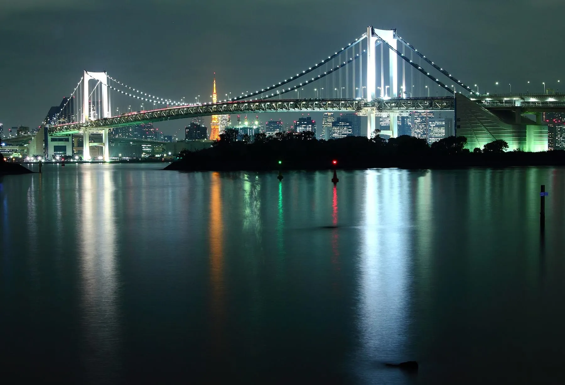 Rainbow Bridge lit up at night over Tokyo Bay