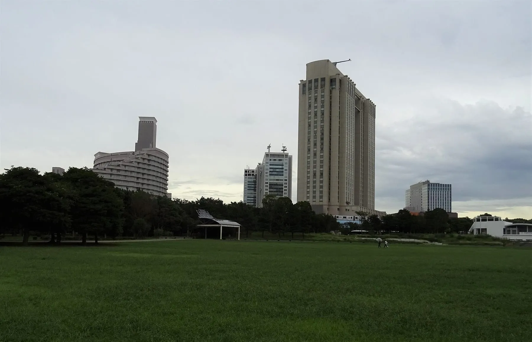 The lawn of Shiokaze Park, with hotels in Daiba behind